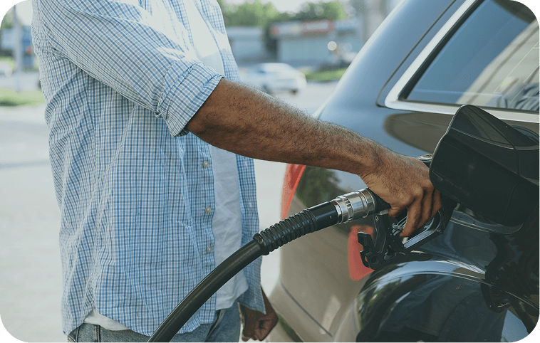 Driver refuelling a car at a fuel pump